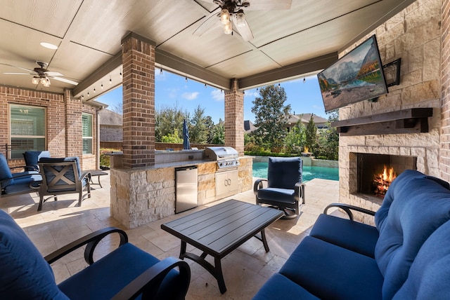 view of patio with grilling area, area for grilling, and an outdoor living space with a fireplace