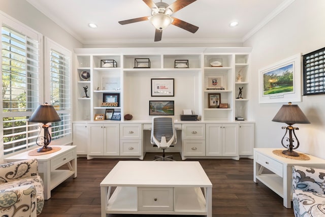 office featuring dark wood finished floors, built in desk, crown molding, and a ceiling fan