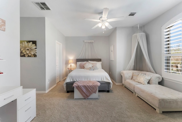 bedroom featuring baseboards, visible vents, and light carpet