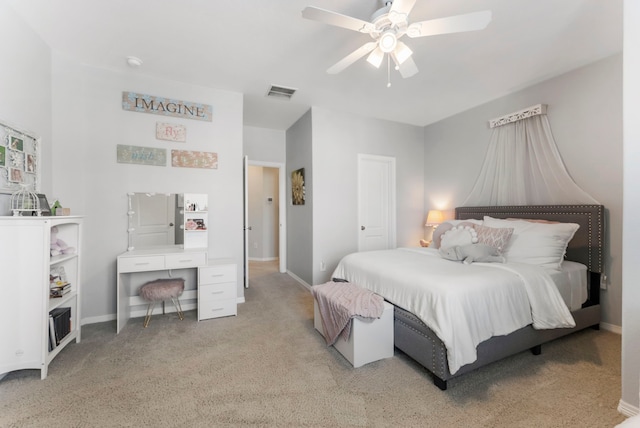 bedroom featuring light carpet, visible vents, a ceiling fan, and baseboards