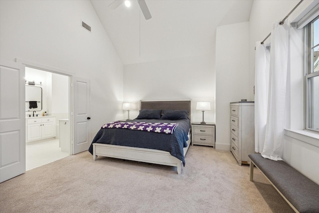 727 Dorothy St, Houston, TX 77007 - bedroom with light colored carpet, high vaulted ceiling, connected bathroom, and ceiling fan