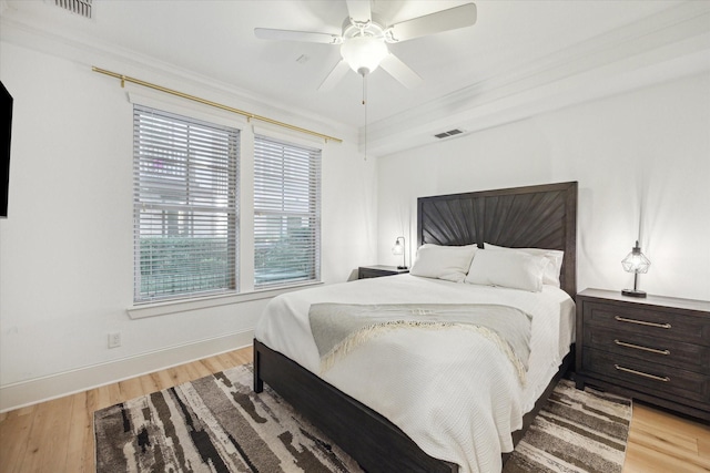 727 Dorothy St, Houston, TX 77007 - bedroom with light wood-style flooring, baseboards, ornamental molding, and ceiling fan