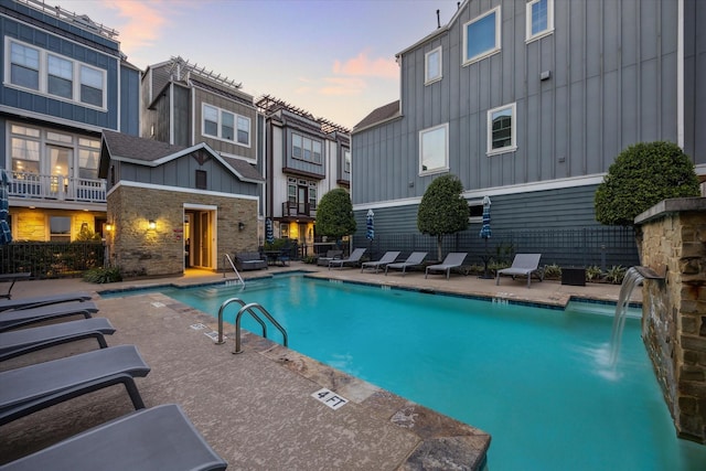 727 Dorothy St, Houston, TX 77007 - pool at dusk featuring a community pool and a patio area