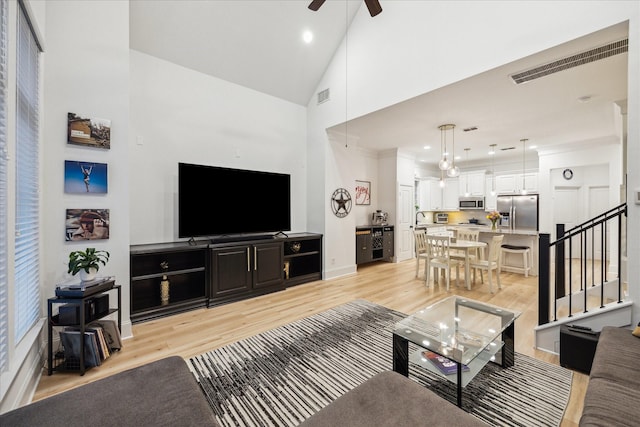 727 Dorothy St, Houston, TX 77007 - living area with light wood-style floors, ceiling fan, stairs, high vaulted ceiling, and recessed lighting