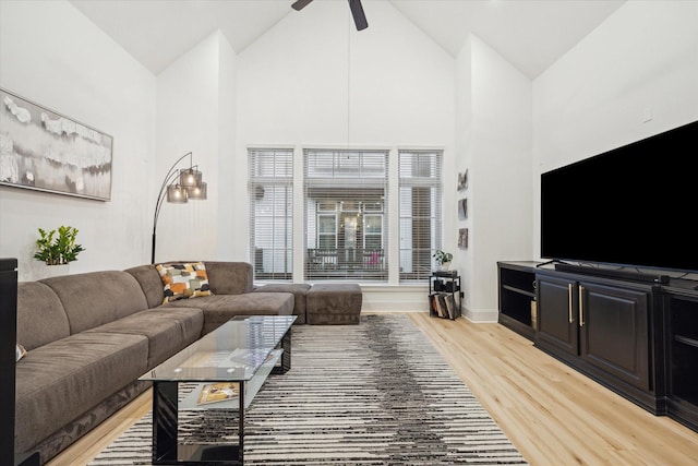 727 Dorothy St, Houston, TX 77007 - living area with high vaulted ceiling, light wood-style flooring, a ceiling fan, and baseboards