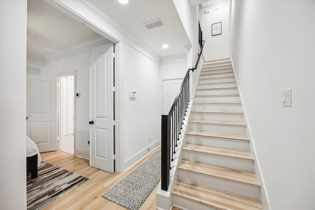 727 Dorothy St, Houston, TX 77007 - stairway with crown molding, wood finished floors, recessed lighting, and baseboards