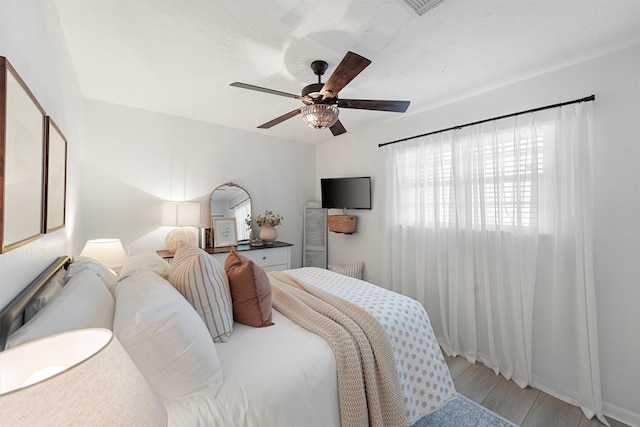 bedroom featuring light wood-type flooring and a ceiling fan