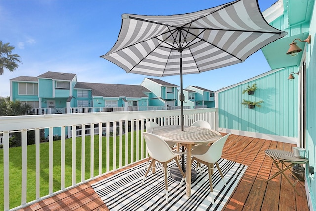 deck featuring a residential view and a yard