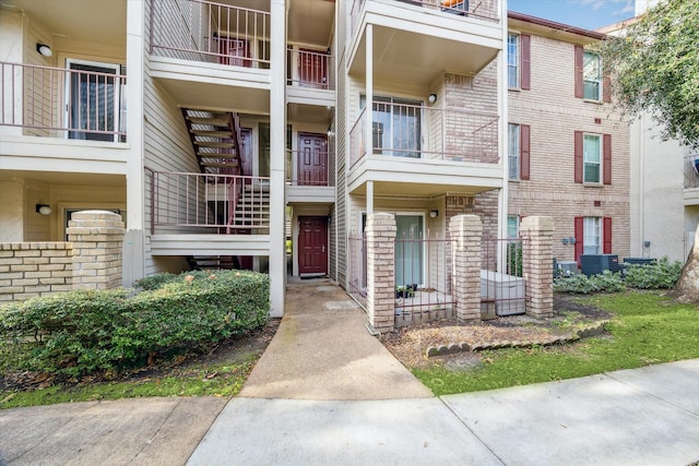 view of property with stairway and central AC