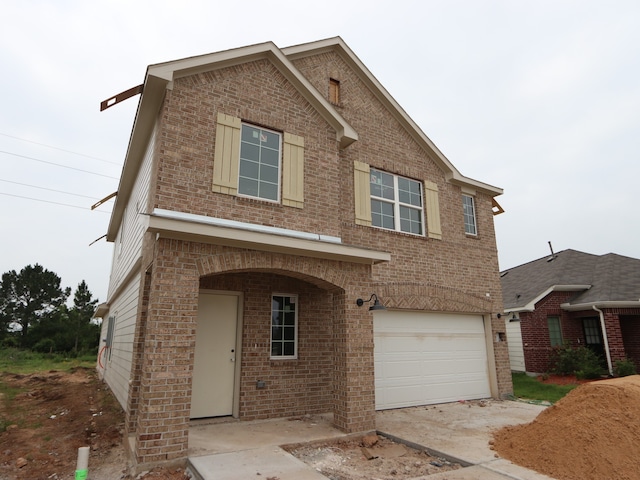 32039 Splendor Dr, Fulshear, TX 77441 - view of front facade with brick siding, a garage, and driveway