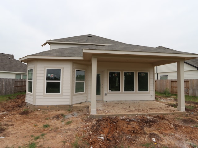 32039 Splendor Dr, Fulshear, TX 77441 - rear view of house featuring a patio area and roof with shingles