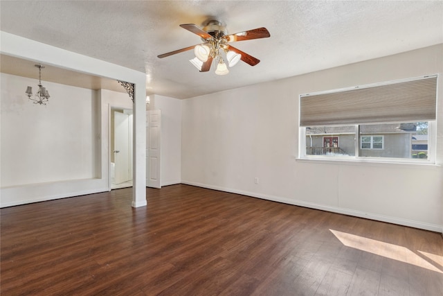 empty room featuring ceiling fan, wood finished floors, baseboards, and a textured ceiling