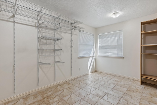 spacious closet with marble finish floor