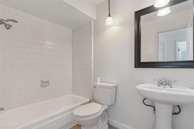 full bathroom featuring toilet, bathing tub / shower combination, and baseboards