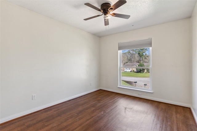 unfurnished room with baseboards, a textured ceiling, dark wood finished floors, and a ceiling fan