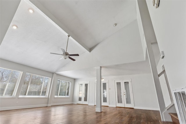 unfurnished living room featuring stairway, wood finished floors, baseboards, vaulted ceiling, and french doors