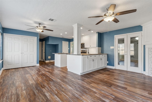 kitchen featuring visible vents, white cabinets, french doors, and dark wood-style flooring