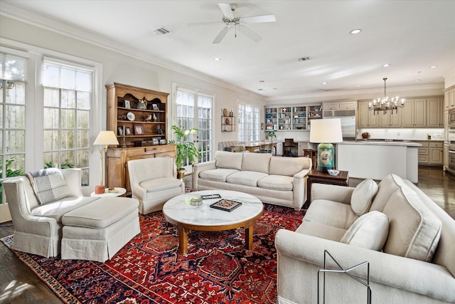 living area featuring visible vents, plenty of natural light, and ornamental molding