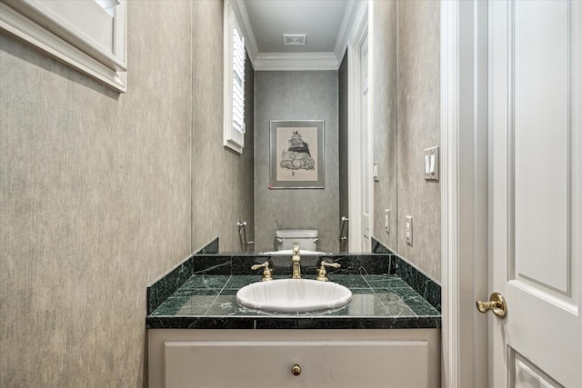 bathroom featuring visible vents, vanity, toilet, and crown molding