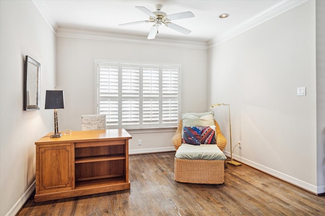 sitting room featuring ceiling fan, dark wood-type flooring, baseboards, and ornamental molding