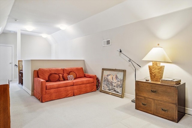 carpeted living area with visible vents, baseboards, and vaulted ceiling