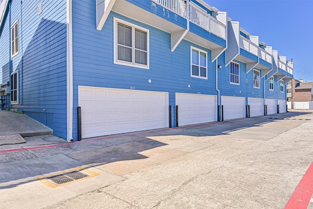 view of side of home featuring a garage and a residential view