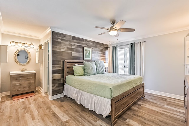 bedroom with baseboards, light wood-style flooring, and ornamental molding