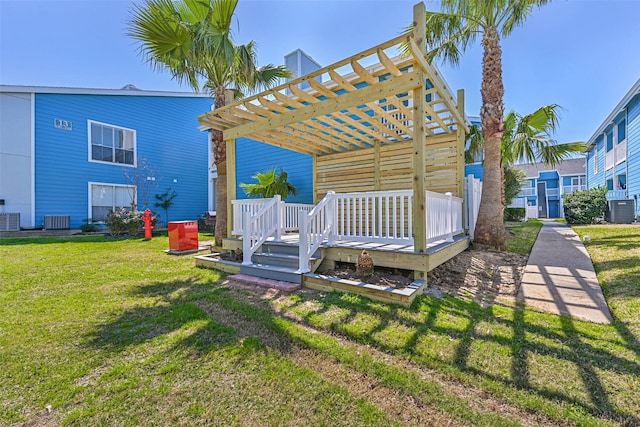 view of yard with central air condition unit, a deck, and a pergola