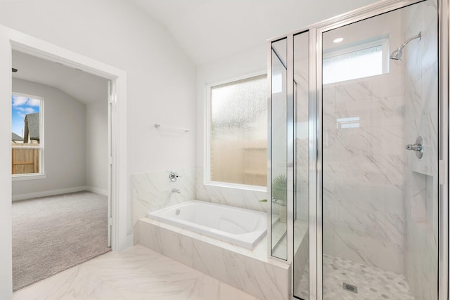 bathroom featuring lofted ceiling, a garden tub, marble finish floor, and a marble finish shower