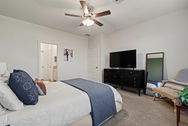 bedroom featuring a ceiling fan, ensuite bath, carpet, and visible vents