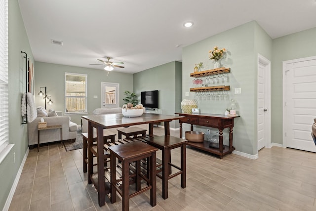 dining area featuring a ceiling fan, visible vents, light wood finished floors, baseboards, and recessed lighting