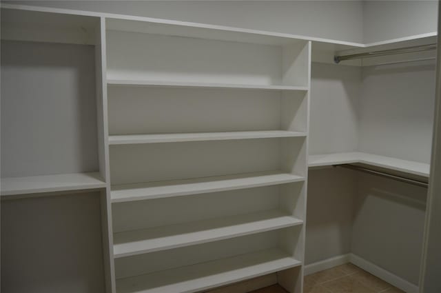 spacious closet with tile patterned floors