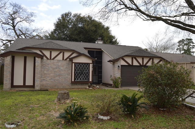 english style home with brick siding, a front yard, stucco siding, a chimney, and a garage