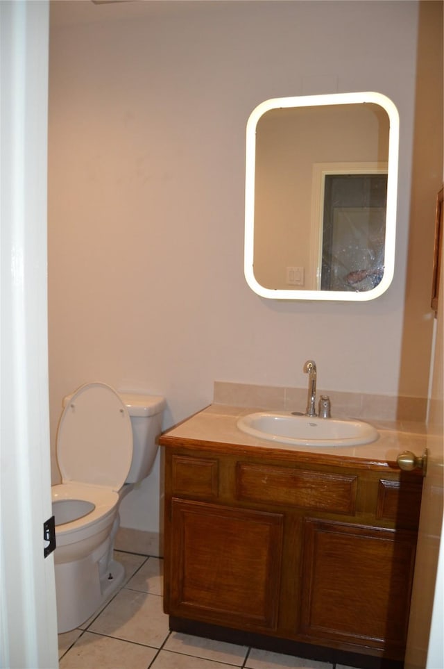 bathroom featuring vanity, tile patterned floors, and toilet