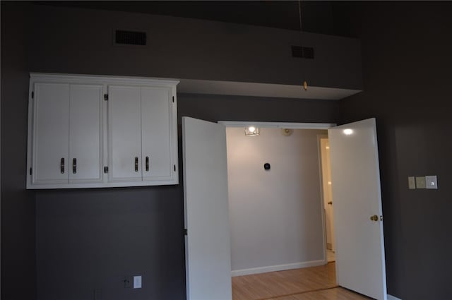 interior space featuring visible vents, baseboards, and light wood-style floors