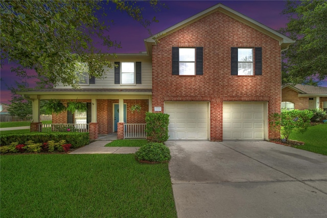 view of front facade with an attached garage, covered porch, a front lawn, concrete driveway, and brick siding