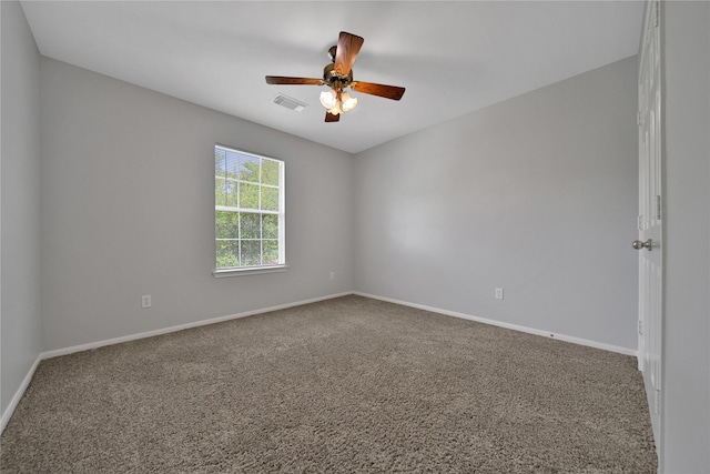 spare room with visible vents, baseboards, a ceiling fan, and carpet flooring