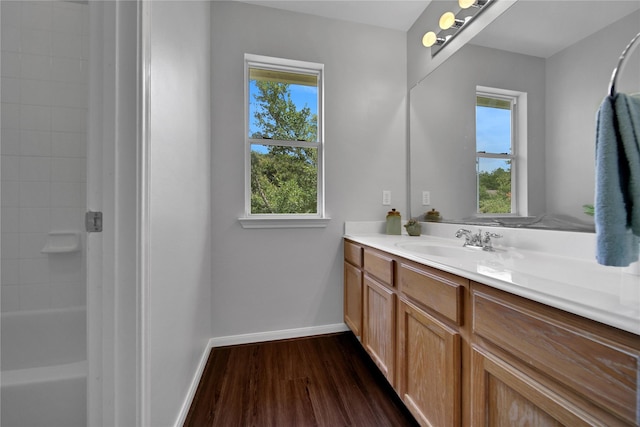 bathroom featuring baseboards, wood finished floors, and vanity