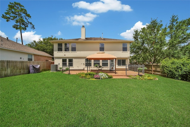 rear view of house with a gazebo, a lawn, a chimney, and a patio