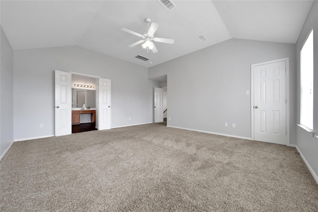 unfurnished bedroom with visible vents, baseboards, carpet, and vaulted ceiling