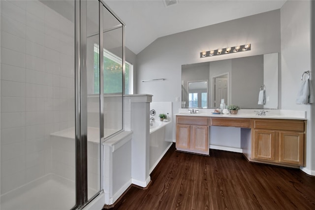 full bathroom featuring vaulted ceiling, a stall shower, wood finished floors, a bath, and a sink