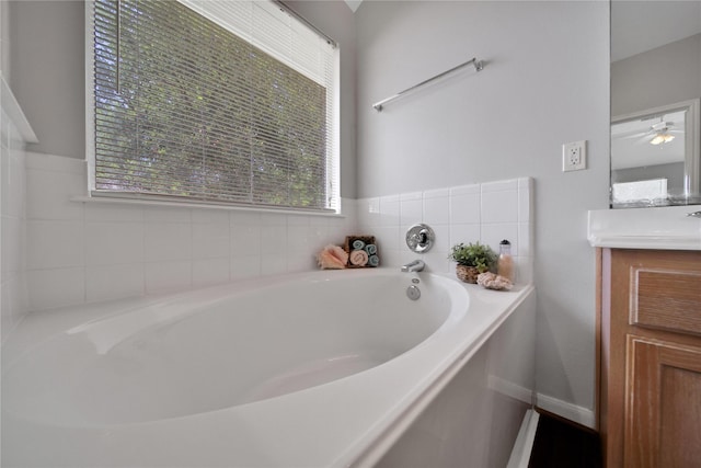 bathroom with a garden tub and vanity