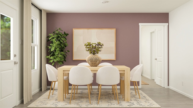 dining room with baseboards and light wood finished floors