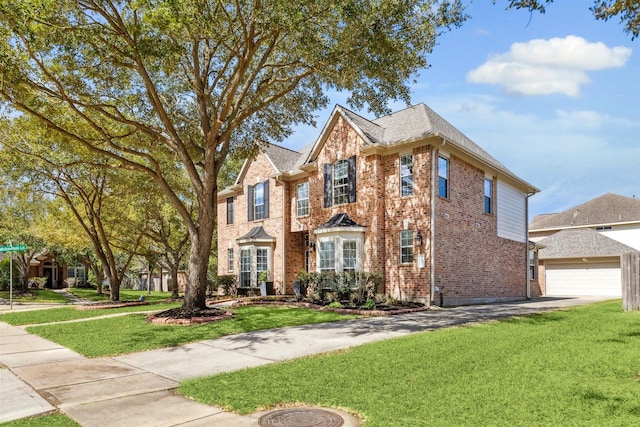 view of front facade with a garage, brick siding, and a front lawn