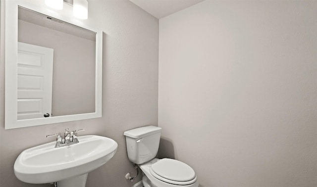 half bath with a sink and toilet