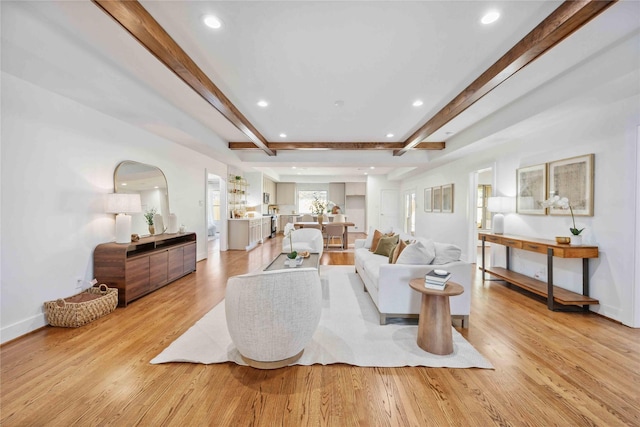 living room with recessed lighting, beamed ceiling, baseboards, and light wood finished floors