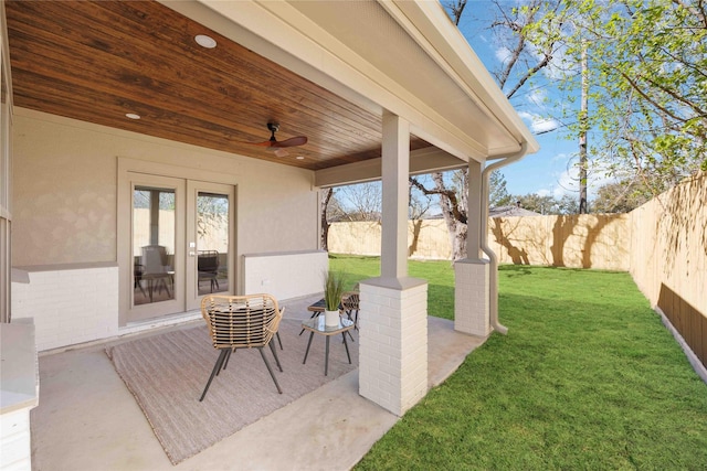 view of patio featuring a ceiling fan, a fenced backyard, and french doors