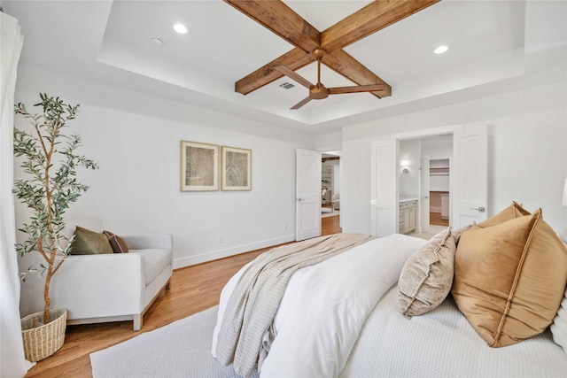 bedroom featuring light wood finished floors, visible vents, coffered ceiling, and baseboards