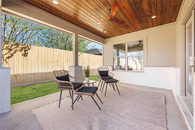 view of patio / terrace with a ceiling fan and fence