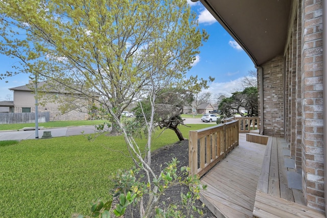 wooden terrace with a yard